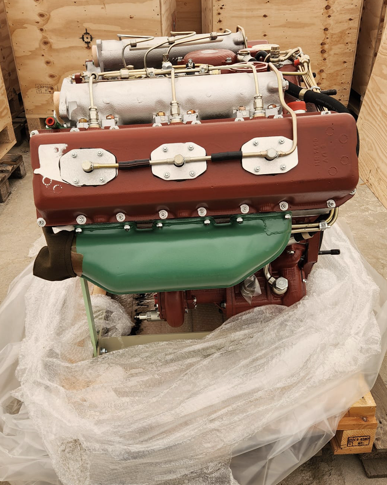 an Image of an engine being unwrapped from a cargo box
